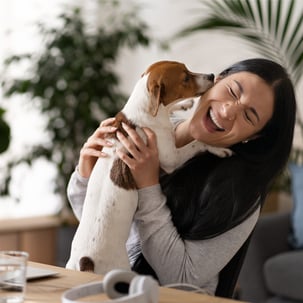Woman business owner with her dog in her arms