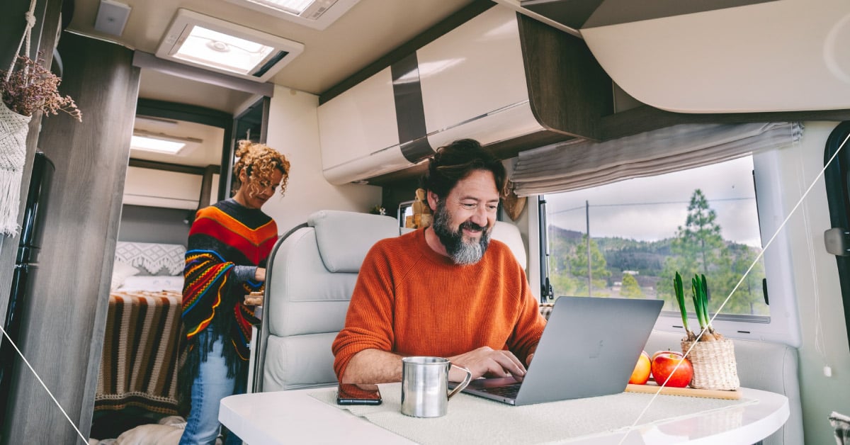Person working on a laptop in an RV 