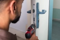Locksmith - a guy changing out the door lock