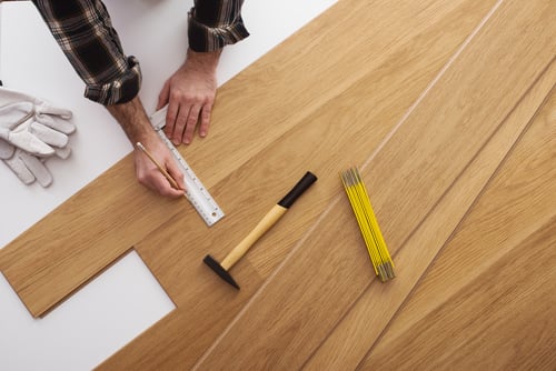 Carpenter installing wood floor