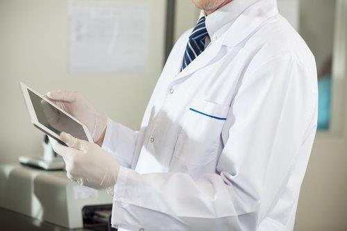 Medical Journal - guy in lab coat with tablet